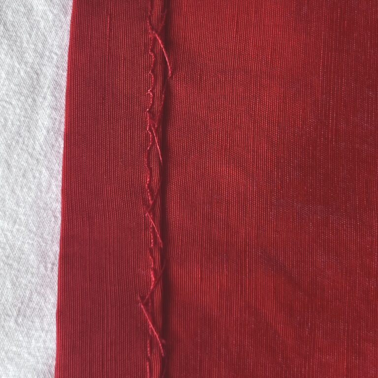 Herringbone stitch - hem stitched by hand